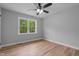 Empty bedroom features hardwood floors and a large window at 2712 Cameron Dr, Sanford, NC 27332