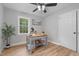 Bright bedroom features a rustic desk, natural light, and contemporary ceiling fan at 2712 Cameron Dr, Sanford, NC 27332