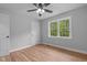 Empty bedroom with hardwood floors, a ceiling fan, and a window allowing ample natural light at 2712 Cameron Dr, Sanford, NC 27332