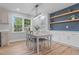 Dining room with modern chandelier, built-in shelves, and a large window at 2712 Cameron Dr, Sanford, NC 27332