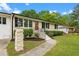 Beautiful single-story home with brick pillar, walkway, well-maintained lawn, and a lovely orange front door at 2712 Cameron Dr, Sanford, NC 27332