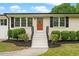 Charming front entrance with a brick facade, contrasting shutters, and a welcoming front door wreath at 2712 Cameron Dr, Sanford, NC 27332