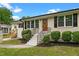 Inviting single-story home with manicured lawn, walkway to the charming front door, and black shutters at 2712 Cameron Dr, Sanford, NC 27332