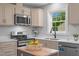 Modern kitchen featuring stainless steel appliances, island, and bright natural light at 2712 Cameron Dr, Sanford, NC 27332