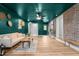 Inviting living room features a brick wall, wood floors, and stylish decor at 2712 Cameron Dr, Sanford, NC 27332