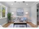 Bright living room featuring wood floors, neutral colors, a large window, and stylish decor at 2712 Cameron Dr, Sanford, NC 27332