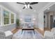 Inviting living room featuring hardwood floors, a ceiling fan, large windows, and neutral colors at 2712 Cameron Dr, Sanford, NC 27332