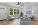 Comfortable living room features hardwood floors, a neutral color scheme, and natural light from the large window at 2712 Cameron Dr, Sanford, NC 27332