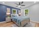 Stylish main bedroom with a navy accent wall, modern decor, and hardwood floors at 2712 Cameron Dr, Sanford, NC 27332