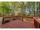 Relaxing backyard view from the wooden deck surrounded by mature trees at 286 Trillium Way, Clayton, NC 27527