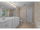 Bright bathroom with double sink vanity, linoleum flooring, and decorative wallpaper at 286 Trillium Way, Clayton, NC 27527