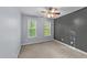 Bedroom featuring neutral carpet, light gray and dark gray walls, natural light, and a ceiling fan at 286 Trillium Way, Clayton, NC 27527