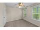 Cozy bedroom featuring natural light, a ceiling fan, neutral walls and carpet creating a peaceful retreat at 286 Trillium Way, Clayton, NC 27527