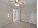 Bedroom with neutral walls, carpet, ceiling fan, natural light, and doorway leading to another room at 286 Trillium Way, Clayton, NC 27527