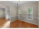 Bright dining room featuring hardwood floors, chair rail molding, and multiple windows at 286 Trillium Way, Clayton, NC 27527