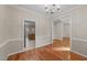 This spacious dining room features hardwood floors, chair rail molding, and an elegant chandelier at 286 Trillium Way, Clayton, NC 27527