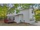 Side view of a two-story home with vinyl siding, a deck, and an attached garage at 286 Trillium Way, Clayton, NC 27527