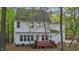 Rear exterior with deck, white siding, and lots of tree coverage on the property at 286 Trillium Way, Clayton, NC 27527
