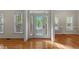 Front entryway with decorative glass door, sidelights, and hardwood floors at 286 Trillium Way, Clayton, NC 27527