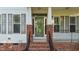 Inviting front entrance with brick steps, decorative door, and sidelight windows at 286 Trillium Way, Clayton, NC 27527