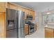 Modern kitchen with stainless steel refrigerator, microwave, and gas range oven at 286 Trillium Way, Clayton, NC 27527