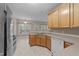Functional kitchen featuring wood cabinets, laminate countertops, double basin sink, and white appliances at 286 Trillium Way, Clayton, NC 27527