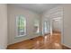 Bright living area with hardwood floors, large windows, and entry into the foyer at 286 Trillium Way, Clayton, NC 27527