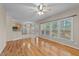 Open concept living room with hardwood floors, eat-in kitchen and big windows at 286 Trillium Way, Clayton, NC 27527