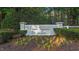 The Gardens community entrance sign landscaped with plants and mulch at 286 Trillium Way, Clayton, NC 27527