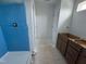 Bathroom with a blue accent wall, shower, and vanity area with modern fixtures at 311 Chesapeake Commons St # 101, Garner, NC 27529