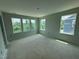 Spacious, bright bedroom featuring large windows offering natural light and serene outdoor views at 311 Chesapeake Commons St # 101, Garner, NC 27529