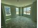 Spacious bedroom featuring three large windows providing natural light and views of the surrounding neighborhood at 311 Chesapeake Commons St # 101, Garner, NC 27529