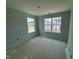 Bedroom featuring two windows with neighborhood views, awaiting personalization at 311 Chesapeake Commons St # 101, Garner, NC 27529