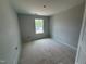 A bedroom with a window showcasing the natural light and simple design, ready to be personalized at 311 Chesapeake Commons St # 101, Garner, NC 27529