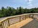 Outdoor deck showcasing a wooden railing with views of the surrounding trees at 311 Chesapeake Commons St # 101, Garner, NC 27529