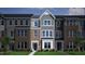 Charming townhome featuring brick and siding exterior, creating an inviting curb appeal at 311 Chesapeake Commons St # 101, Garner, NC 27529