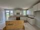 Bright kitchen featuring white cabinets, ample counter space, and natural light from surrounding windows at 311 Chesapeake Commons St # 101, Garner, NC 27529