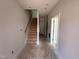 An entryway with a staircase, leading to upper levels, enhancing the home's spacious layout at 311 Chesapeake Commons St # 101, Garner, NC 27529