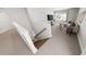 View of the living room from the top of a bright staircase with carpeted stairs at 331 Beacon Dr, Pittsboro, NC 27312