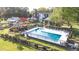 Aerial view of pool, landscaped backyard, manicured lawn, and large brick home on a sunny day at 3542 Bason Rd, Mebane, NC 27302