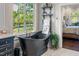 Elegant bathroom with a black clawfoot tub positioned by a window with a view, shelves, and marble floors at 3542 Bason Rd, Mebane, NC 27302