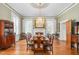 Traditional dining room with a chandelier, fireplace, and hardwood floors at 3542 Bason Rd, Mebane, NC 27302