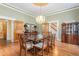 Elegant dining room featuring a glass-top table, chandelier, and hardwood floors at 3542 Bason Rd, Mebane, NC 27302