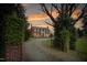 Brick home with a circular driveway and greenery-covered pillars at the entrance at 3542 Bason Rd, Mebane, NC 27302