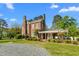 Attractive brick home with a covered porch and patio area, set in a lush green yard at 3542 Bason Rd, Mebane, NC 27302