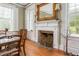 Dining room fireplace with decorative mantel and windows at 3542 Bason Rd, Mebane, NC 27302