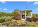 Backyard gazebo surrounded by lush landscaping, winding stone path, and flowering shrubs at 3542 Bason Rd, Mebane, NC 27302