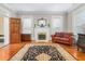 Bright living room with hardwood floors, fireplace, and an oriental rug at 3542 Bason Rd, Mebane, NC 27302