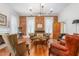 Cozy living room with a brick wall, hardwood floors, a fireplace, and vintage furniture at 3542 Bason Rd, Mebane, NC 27302