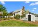 Charming outbuilding with white picket fence, manicured lawn and blooming bushes on a sunny day at 3542 Bason Rd, Mebane, NC 27302